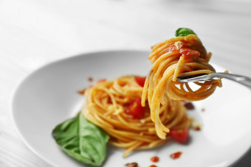 Fork with tasty pasta, close up