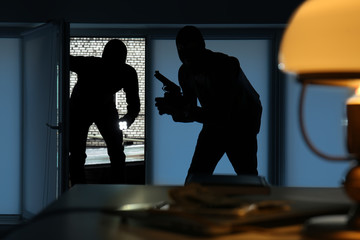 Armed thieves entering a house