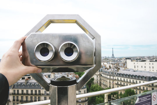 France, Paris, binoculars with the city and the Eiffel Tower in the background