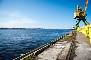 Fototapeta premium old crane with rusty metal rails near sea port