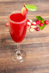 Carandas-plum  juice  in a glass on wooden background  