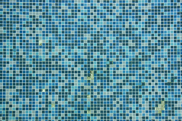 Broken blue ceramic tiled texture background of swimming pool.