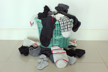 Overflowing socks green plastic basket