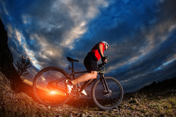 mountain bicycle rider on the hill with sunrise background