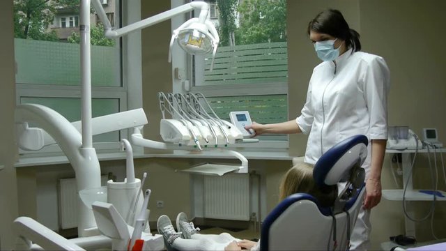 Dentist dental chair lifts with a girl