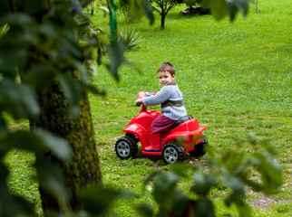 Boy riding atv toy