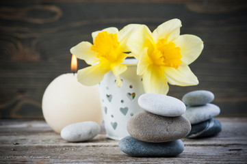 Fototapeta na wymiar Balancing pebble stones and yellow flowers