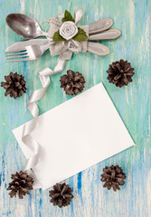 Christmas dinner table setting with rustic decorations. Hanging decoration turquoise shabby table wooden Top view, flat lay with copyspace slogan text message. party invitation corporate event