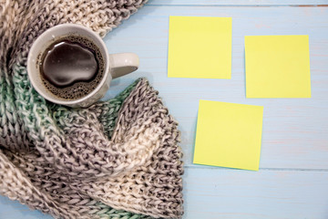 Cosy soft winter background, knitted sweater Cup hot coffee old vintage wooden board. Christmas holidays at home. place for text, Top view, flat lay with copy space  slogan or  message