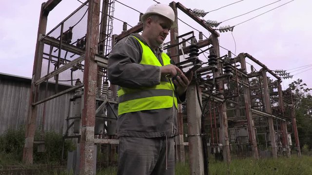 Electrician take pictures in electrical substation
