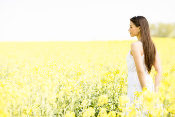 Fototapeta premium Young woman in the spring field