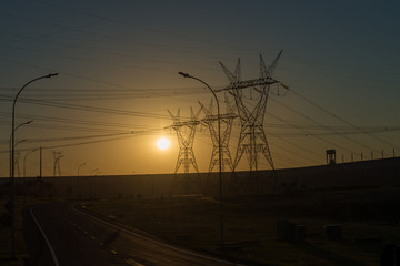 Fototapeta na wymiar Power lines at the sunset near Itaipu dam