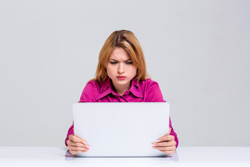 Fototapeta premium young woman sitting in the table and using laptop
