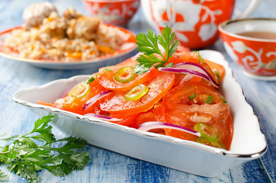 Vegetable salad from tomatoes with onions and hot peppers