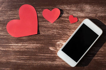 Smart phone and red hearts