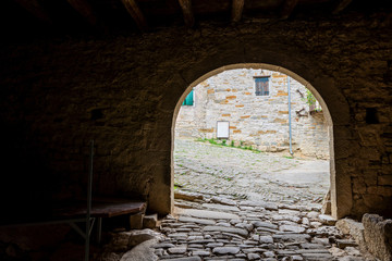 Dark passageway with arch to the light