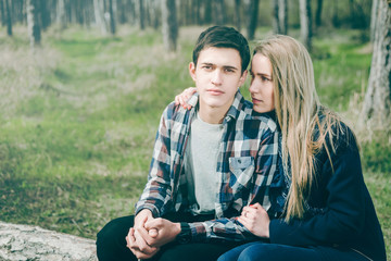 Happy young couple sitting on the tree