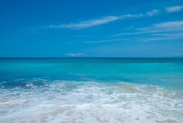 Sea foam after the waves on the beach of Dreamland. Bali, Indonesia