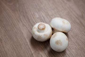 Champignon mushrooms on wooden table
