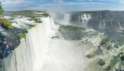 The Iguazu Falls with clouds and blue sky