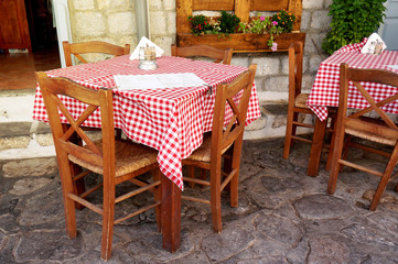 Traditional Greek Tavern Tables Covered in Red and White Checkered Gingham Tablecloth