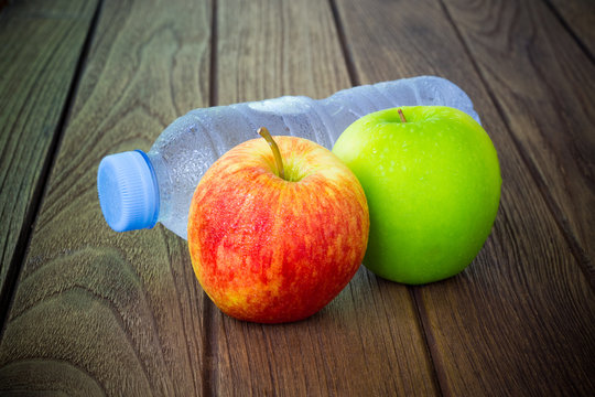 Healthy eating concept, bottle of water, fresh red and green app