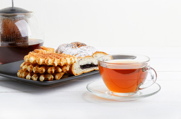 Tea and pastry on white wooden table