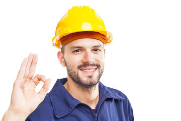 Smiling worker gesturing OK sign, isolated on white background