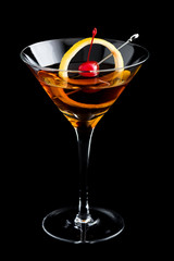 Manhattan cocktails on black background with garnish