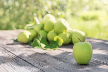 green apples on wooden background outdoor