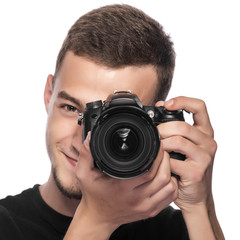 Fototapeta premium Handsome young man holding a DSLR camera.