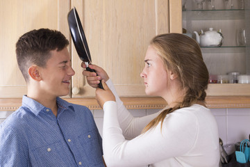 Teenage siblings having fight in kitchen