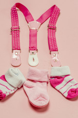 Cotton baby socks for newborn on a colorful pink background. Copy space