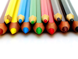 Set of big and small color pencils on white background, macro, shallow depth of field