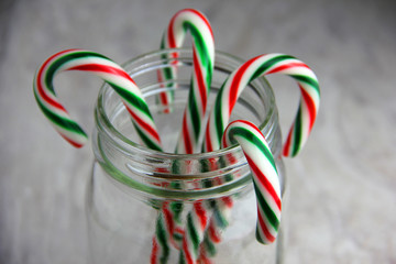 Candy Canes in a Glass Jar Set On a White Background