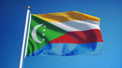Comoros flag waving against clean blue sky, close up, isolated with clipping path mask alpha channel transparency