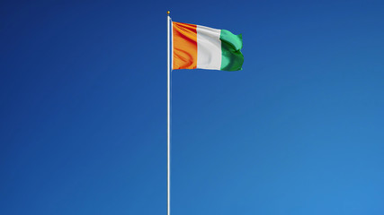 Cote Ivoire flag waving against clean blue sky, long shot, isolated with clipping path mask alpha channel transparency