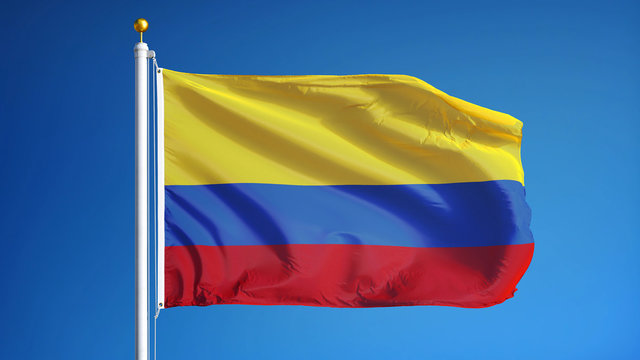 Colombia flag waving against clean blue sky, close up, isolated with clipping path mask alpha channel transparency