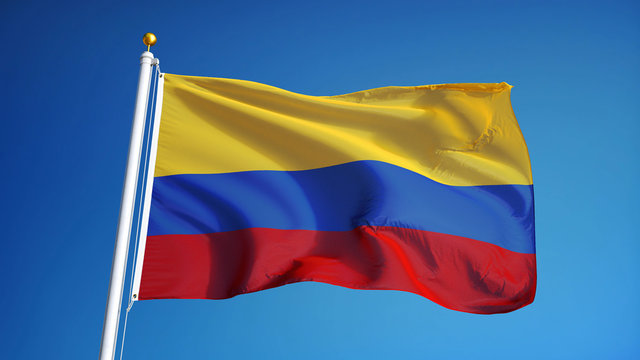 Colombia flag waving against clean blue sky, close up, isolated with clipping path mask alpha channel transparency