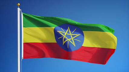 Ethiopian flag waving against clean blue sky, close up, isolated with clipping path mask alpha channel transparency