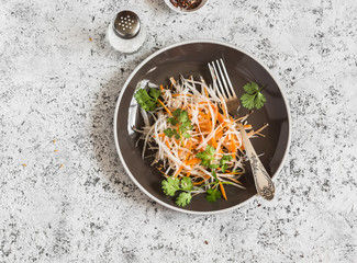 Daikon and carrot slaw. Healthy vegetarian food. On a light background, top view