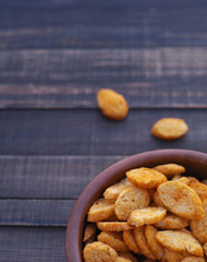 Сroutons from white bread in wooden bowl on a wooden surface of a table.