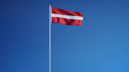 Latvia flag waving against clean blue sky, long shot, isolated with clipping path mask alpha channel transparency