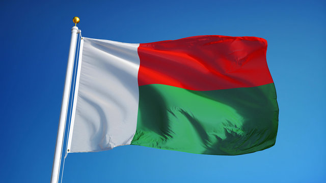 Madagascar flag waving against clean blue sky, close up, isolated with clipping path mask alpha channel transparency