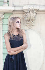 Fototapeta premium An outdoor fashion gothic style portrait of a beautiful blonde girl