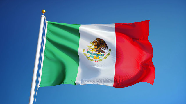 Mexico flag waving against clean blue sky, close up, isolated with clipping path mask alpha channel transparency