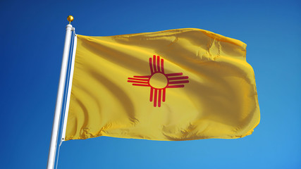 New Mexico flag waving against clean blue sky, close up, isolated with clipping path mask alpha channel transparency