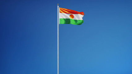Niger flag waving against clean blue sky, long shot, isolated with clipping path mask alpha channel transparency
