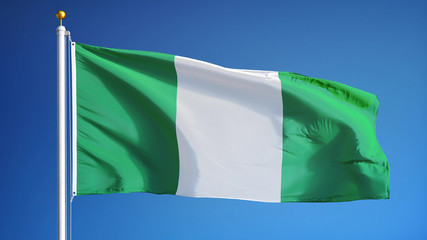 Nigeria flag waving against clean blue sky, close up, isolated with clipping path mask alpha...