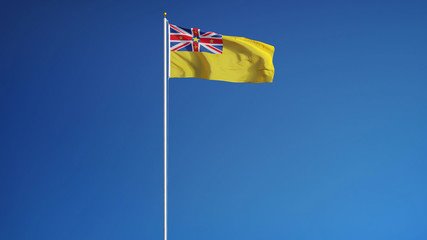 Niue flag waving against clean blue sky, long shot, isolated with clipping path mask alpha channel transparency